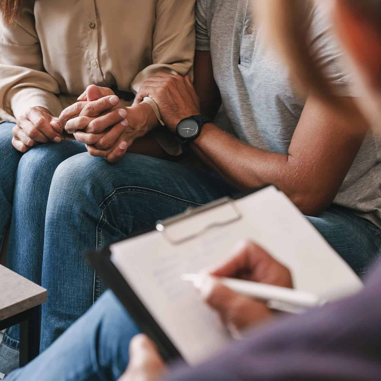 couple holding hands during family therapy