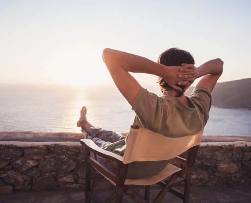 Image of a person enjoying the sunset on the beach.