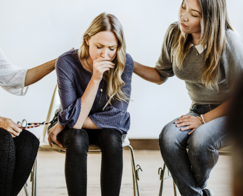 woman struggling with addiction opening up to family and friends during addiction intervention