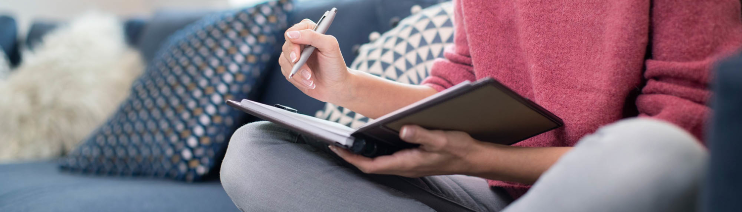 woman journaling as part of an at-home addiction treatment program