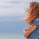 woman with crossed arms looking out over water