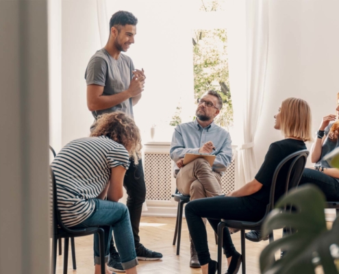 group of people meeting to discuss how to break the cycle of addiction