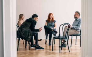 Psychotherapist talking with rebellious teenagers with alcohol addiction