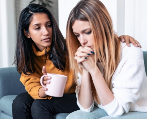 Picture of a companion comforting a distressed person.