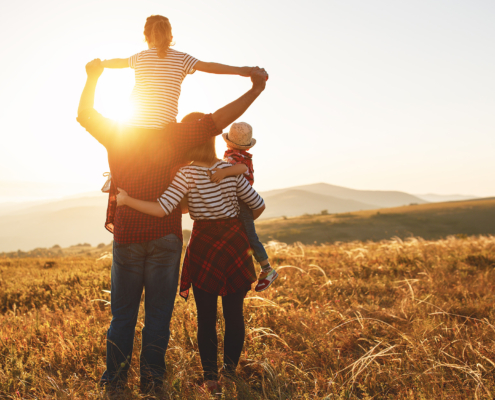 Happy family: mother, father, children son and daughter on sunset