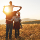 Happy family: mother, father, children son and daughter on sunset