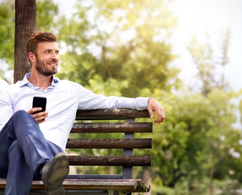 Business man relaxing on park bench