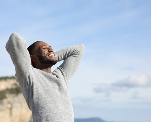 Relaxed man breathing in the mountain
