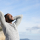 Relaxed man breathing in the mountain