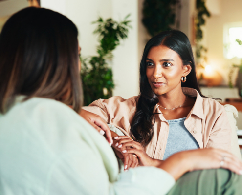 Happy, talking and friends with women on sofa