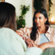 Happy, talking and friends with women on sofa